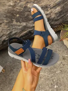 Detail of blue strappy flat sandals with snowflake pattern and comfortable thick sole