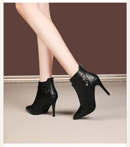 Side detail of black pointed-toe stiletto boots with elegant textured finish