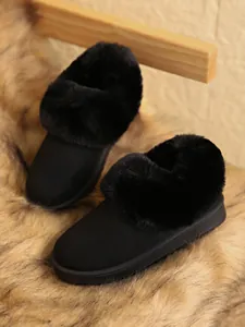 Detail showing plush black faux fur trim and matte finish of warm winter snow boots