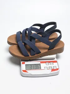 Detail of navy blue elastic strap flat Roman sandals on a scale weighing 313.6g