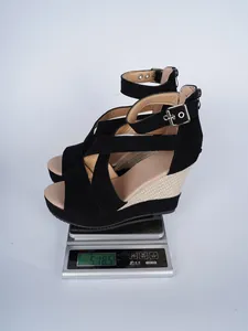 Detailed shot showing the 518.5g weight of these black suede high wedge sandals