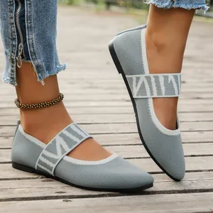 Close-up of grey breathable knit slip-on ballet flats with geometric cross straps