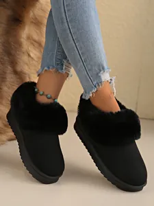Detailed view of women's black snow boots featuring plush faux fur trim and warm lining