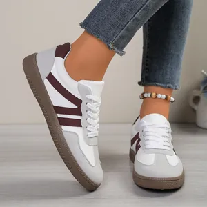 Stylish women's German army trainer sneakers with white and grey suede colorblock design