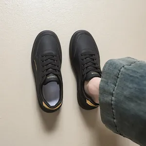 Top-down view of stylish black low-top platform sneakers paired with casual denim jeans