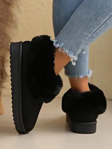 Warm black platform snow boots for women featuring a stylish fluffy faux fur cuff detail