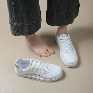 Detailed view of women's white leather casual sneakers with comfortable chunky platform soles