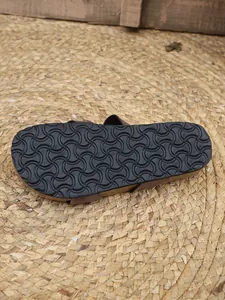 Bottom view showing the textured non-slip rubber outsole of women's cork flat sandals