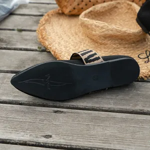 Detailed view of black fly-knit mule sole with anti-slip pattern and size marking.