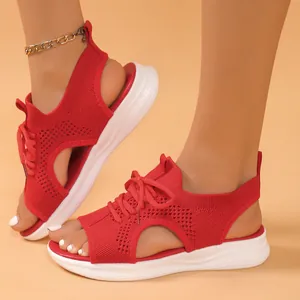 Detail view of red knit sporty sandals featuring a hollow out design and thick white soles
