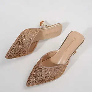 Elegant pointed-toe kitten heel mules featuring shimmering rhinestone embellishments