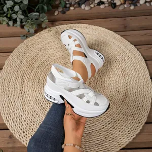 White platform sandals with closed-toe cutout design and comfortable velcro strap for summer.