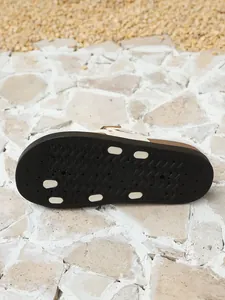 Detailed view of black anti-slip textured outsole for women's platform slippers.