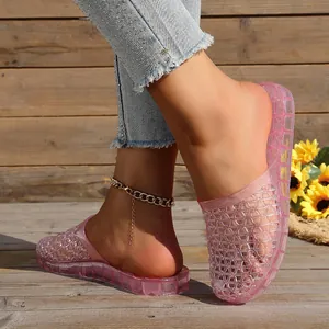 Close-up detail of pink hollow-out jelly slippers with glitter and breathable design for summer