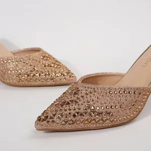 Elegant rose gold pointed-toe mules decorated with sparkling rhinestone embellishments