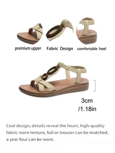 Detail view of beige flat sandals with 3cm heel height and fabric design features.