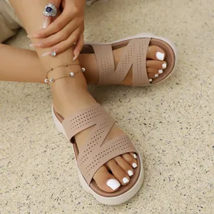 Close-up of comfortable women's beige flyknit flat sandals with a stylish Z-strap design