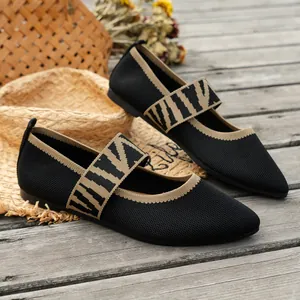 Detail view of comfortable black breathable knitted flats with VIVA patterned strap.