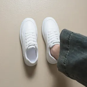 Minimalist white platform sneakers for women with the FASHION logo on the tongue