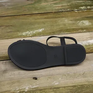 Detailed view of black flat sandal sole with non-slip texture and size 37 mark.