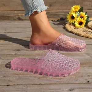 Close-up of pink hollow-out jelly slippers with thick anti-slip soles for summer wear.