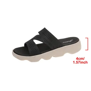Detail view of the 4cm thick platform sole on these black fly-knit casual slides.