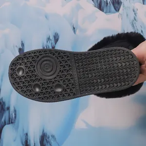Close-up detail of the anti-slip rubber sole pattern on black winter snow boots