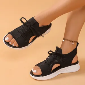 Close-up detail of black sports sandals with breathable knit upper and thick white platform sole