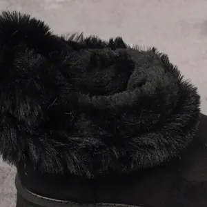 Detailed close-up showing the plush black faux fur lining of winter snow boots