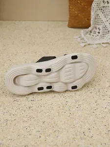 Macro view of the cream-colored textured sole with non-slip inserts for casual sandals