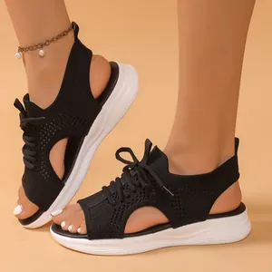 Women's black flyknit sports sandals featuring thick white soles and a hollow design