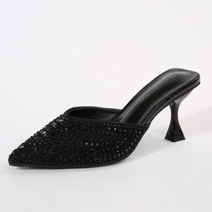 Elegant black pointed toe kitten heel mules featuring a shimmering glitter upper