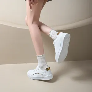 Stylish women's white low-top platform sneakers with gold heel accents and thick sole.