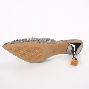 Bottom view showing the non-slip sole and metallic kitten heel of silver rhinestone mules