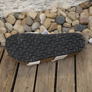 Close-up of anti-slip sole texture on women's white buckle flat sandals