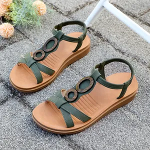 Detailed view of olive green women's flat sandals with retro ring accents and elastic back strap.
