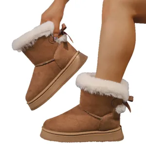Classic brown suede winter snow boots with white faux fur lining and bow detail for women