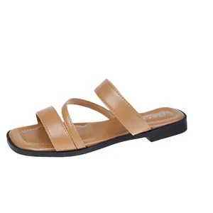 Elegant tan flat sandals for women with three straps and a modern square toe design.