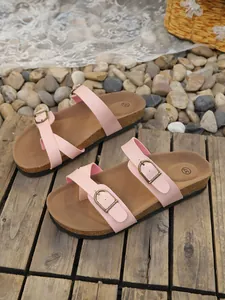Detail view of pink women's flat sandals with adjustable buckles and cork sole