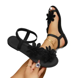 Women's black flat sandals with 3D flower decor and toe loop for summer beach wear.