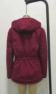 Detail view of burgundy hooded winter parka jacket showing back design and elastic waist