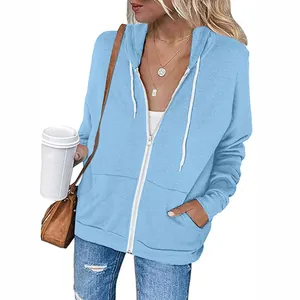 Detailed view of women's light blue zip-up hoodie featuring white drawstrings and pockets