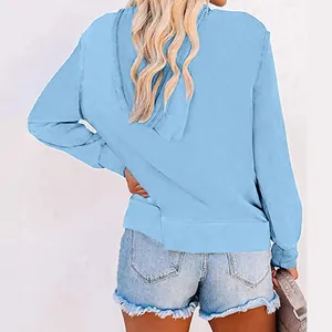 Back view of a light blue solid color long sleeve hooded sweatshirt for women
