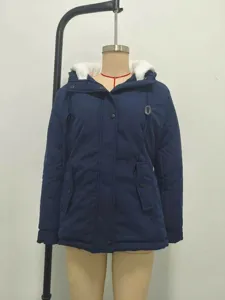 Navy blue mid-length hooded winter parka with warm white faux fur lining displayed on mannequin