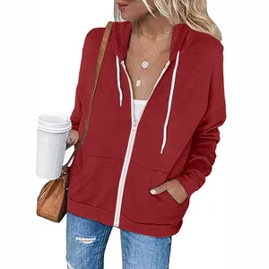 Close-up of a women's maroon zip-up hoodie with white drawstrings and pockets