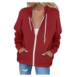 Close-up of a women's dark red zip-up hoodie featuring a white drawstring and pockets.
