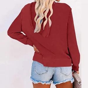 Back view of a women's burgundy zip-up hoodie featuring a drawstring hood and soft fabric.