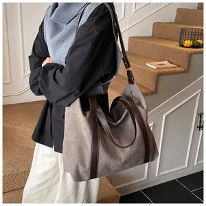 Foto de estilo de vida de una modelo con un bolso tote de lona gris con correas de cuero