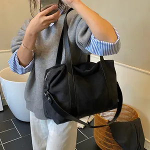 Bolso tote de lona negra de gran capacidad para viajes y desplazamientos diarios con correa
