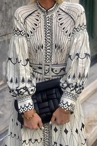 Close-up detail of elegant court style long sleeve printed dress with matching belt